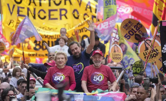 Mayoral candidate Guilherme Boulos of the Socialism and Liberty Party, center, campaigns with Brazilian President Luiz Inacio Lula da Silva, right, and his running mate Marta Suplicy, left, the day before elections in Sao Paulo, Saturday, Oct. 5, 2024. (AP Photo/Andre Penner)