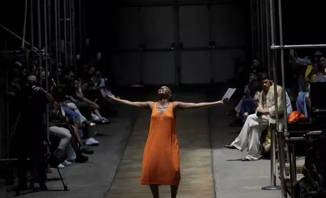A model recites poetry during the presentation of the As Marias collection at the Oficina Theater during Sao Paulo Fashion Week in Sao Paulo, Brazil, Friday, Oct. 18, 2024. (AP Photo/Andre Penner)