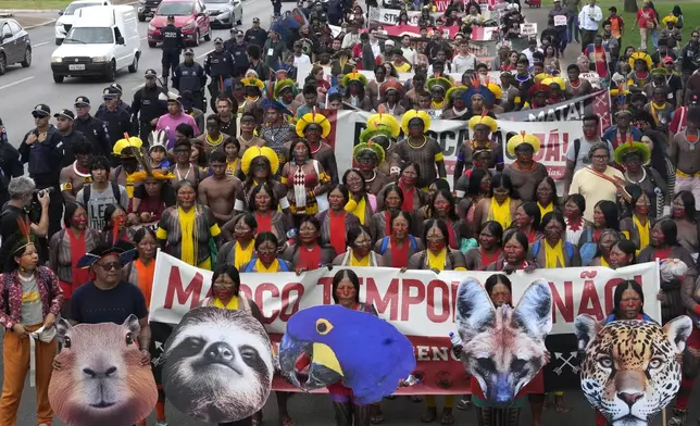 Indigenous groups take part in protest against a proposed constitutional amendment that threatens some of their land rights, in Brasilia, Brazil, Wednesday, Oct. 30, 2024. (AP Photo/Eraldo Peres)