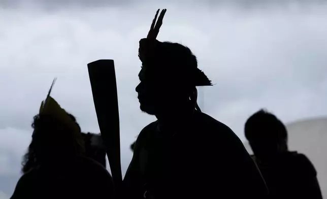 Indigenous people perform a ceremonial dance during a protest against a proposed constitutional amendment that threatens some of their land rights, in Brasilia, Brazil, Wednesday, Oct. 30, 2024. (AP Photo/Eraldo Peres)