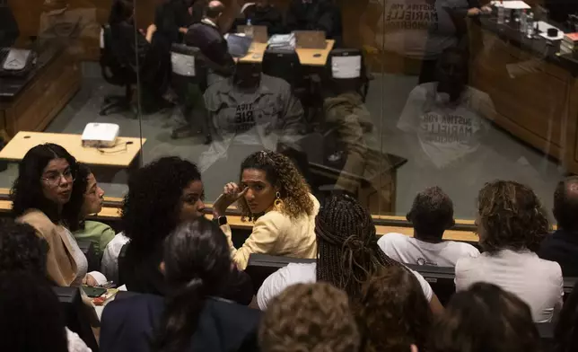Brazil's Minister of Racial Equality Anielle Franco, center, sister of slain councilwoman Marielle Franco, attends the trial of Franco's suspected murderers, at the Court of Justice in Rio de Janeiro, Wednesday, Oct. 30, 2024. (AP Photo/Bruna Prado)