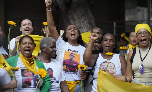 People attend a rally prior to the trial of former Rio de Janeiro city councilwoman Marielle Franco's alleged killers outside the Court of Justice, in Rio de Janeiro, Wednesday, Oct. 30, 2024. (AP Photo/Silvia Izquierdo)