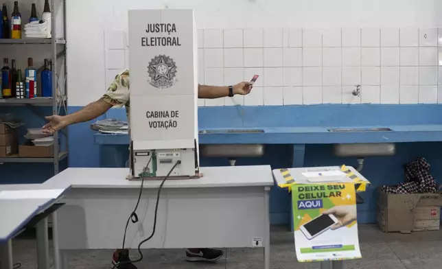 A man votes in municipal elections in the Rocinha community of Rio de Janeiro, Sunday, Oct. 6, 2024. (AP Photo/Bruna Prado)