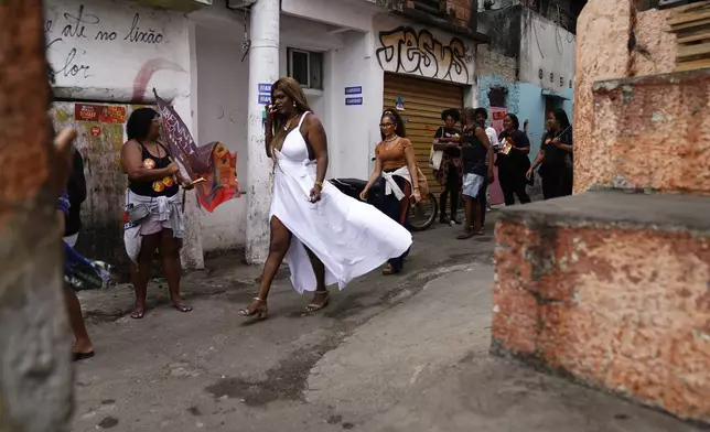 Benny Briolly, center, a transgender woman running for city council, canvases with supporters and members of her campaign team in Morro do Estado, in Niteroi, Rio de Janeiro state, Brazil, Saturday, Sept. 28, 2024. (AP Photo/Hannah-Kathryn Valles)