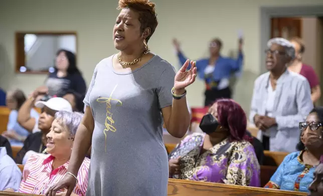 Loreasa Minor, of Turner Station, Md., stands during a service at Mt. Olive Baptist Church, Sunday, Aug. 18, 2024, in Turner Station. Turner Station is located near the former site of the Francis Scott Key Bridge, which collapsed in March. (AP Photo/Steve Ruark)