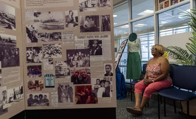 Angie Banks, a volunteer at the Turner Station History Center, is pictured among artifacts and informational posters inside the community museum, Friday, Aug. 16, 2024, in Turner Station, Md. (AP Photo/Stephanie Scarbrough)