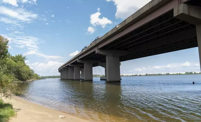 A small beach below the remaining portion of the Francis Scott Key Bridge is seen, Tuesday, Aug. 13, 2024, in Turner Station, Md. The water is unsafe for swimming and fishing from decades of industrial pollution. (AP Photo/Stephanie Scarbrough)