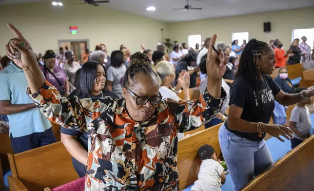 Peggy Whitfield, left, of Baltimore, attends a service at Mt. Olive Baptist Church, Sunday, Aug. 18, 2024, in Turner Station, Md. Turner Station is located near the former site of the Francis Scott Key Bridge, which collapsed in March. (AP Photo/Steve Ruark)