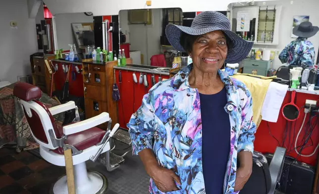 Courtney Speed, of Turner Station, Md., stands in Speed's Barber and Beauty, her salon, Sunday, Aug. 18, 2024, in Turner Station. Turner Station is located near the former site of the Francis Scott Key Bridge, which collapsed in March. (AP Photo/Steve Ruark)