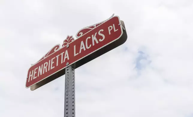 A commemorative street sign in honor of Henrietta Lacks, who lived in Turner Station for almost a decade, is pictured Friday, Aug. 16, 2024, in Turner Station, Md. (AP Photo/Stephanie Scarbrough)