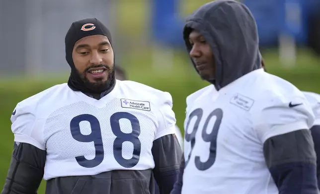 Chicago Bears defensive tackle Gervon Dexter Sr. (99), right, and defensive end Montez Sweat (98), participate in a NFL football training session in Ware, England, Friday, Oct. 11, 2024, ahead of the game against the Jacksonville Jaguars at the Tottenham Hotspur stadium on Sunday. (AP Photo/Kin Cheung)