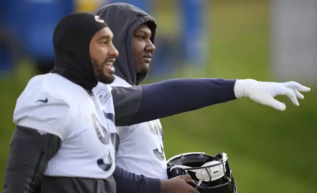 Chicago Bears defensive tackle Gervon Dexter Sr. (99), right, and defensive end Montez Sweat (98), participate in a NFL football training session in Ware, England, Friday, Oct. 11, 2024, ahead of the game against the Jacksonville Jaguars at the Tottenham Hotspur stadium on Sunday. (AP Photo/Kin Cheung)