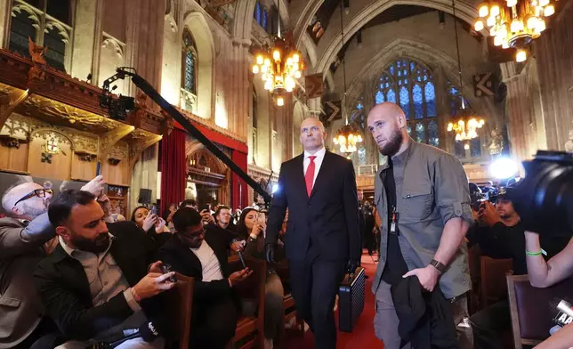 Heavyweight boxer Oleksandr Usyk, left, arrives for a press conference at the Guildhall, London, Wednesday Oct. 23, 2024. (Zac Goodwin/PA via AP)