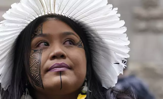 Wakrewa Krenak, from Brazil, stands outside the Royal Courts of Justice in London, Monday, Oct. 21, 2024, as lawyers representing around 620,000 Brazilians as well as businesses, municipal governments, and members of the Krenak indigenous tribe are bringing a multibillion-pound legal action against BHP Group following the collapse of the Fundao dam in November 2015. (AP Photo/Alberto Pezzali)