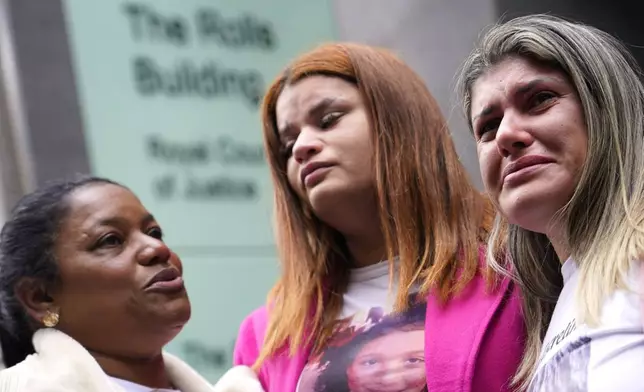 Gelvana Rodrigues, right, who lost her son Thiago, in the Fundao dam disaster, stands with other protesters outside the Royal Courts of Justice in London, Monday, Oct. 21, 2024, as lawyers representing around 620,000 Brazilians as well as businesses, municipal governments, members of the Krenak indigenous tribe are bringing a multibillion-pound legal action against BHP Group following the collapse of the Fundao dam in November 2015. (AP Photo/Alberto Pezzali)