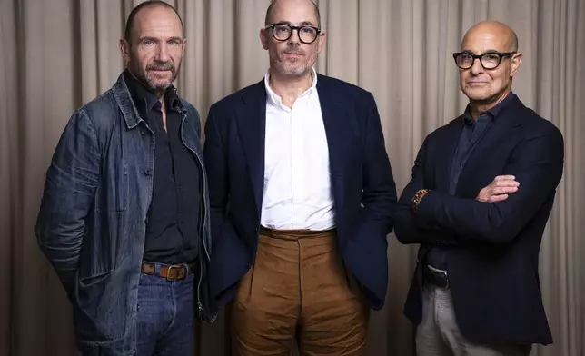 Ralph Fiennes, from left, director Edward Berger and Stanley Tucci pose for portrait photographs for the film "Conclave'"on Thursday, Oct. 10, 2024, in London. (Photo by Scott A Garfitt/Invision/AP)