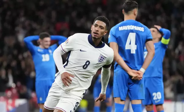 England's Jude Bellingham celebrates after scoring his side's first goal during the UEFA Nations League Group F soccer match between England and Greece at Wembley Stadium in London, Thursday, Oct. 10, 2024. (AP Photo/Kirsty Wigglesworth)