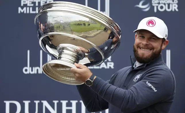 Tyrrell Hatton celebrates with the trophy after winning the Alfred Dunhill Links Championship, at the Old Course St. Andrews, Britain, Sunday Oct. 6, 2024. (Robert Perry/PA via AP)