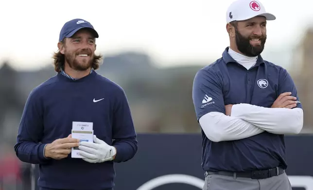 Tommy Fleetwood and John Rahm during day three of the Alfred Dunhill Links Championship at the Old Course, St. Andrews, Scotland, Saturday, Oct. 5, 2024. (Robert Perry/PA via AP)