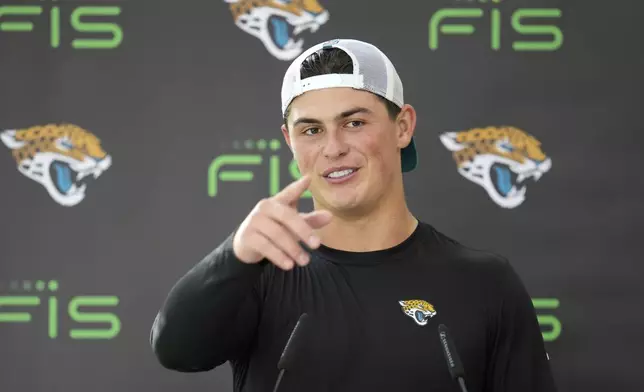 Jacksonville Jaguars wide receiver Louis Rees-Zammit speaks after an NFL football practice session at The Grove in Watford, England, Wednesday, Oct. 16, 2024. (AP Photo/Kin Cheung)