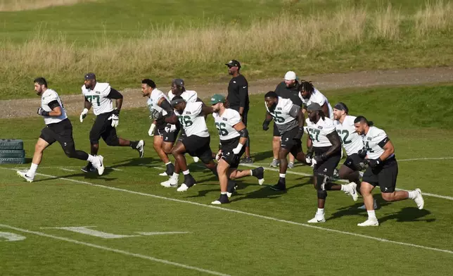 New York Jets center Joe Tippmann (66) and teammates participate in a training session in Ware, England, Friday, Oct. 4, 2024, ahead of the game between New York Jets and Minnesota Vikings at the Tottenham Hotspur stadium on Sunday. (AP Photo/Alastair Grant)