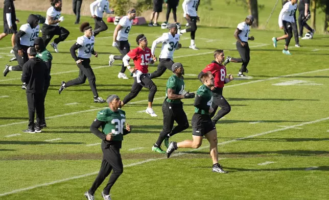 New York Jets quarterback Aaron Rodgers (8) participates in a training session in Ware, England, Friday, Oct. 4, 2024, ahead of the game between New York Jets and Minnesota Vikings at the Tottenham Hotspur stadium on Sunday. (AP Photo/Alastair Grant)