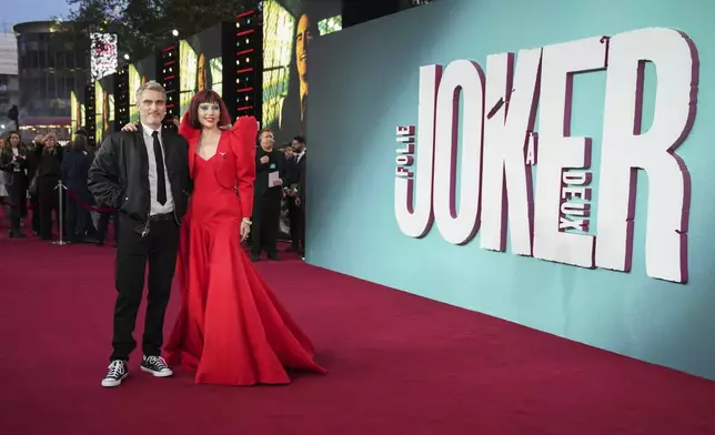 Joaquin Phoenix, left, and Lady Gaga pose for photographers upon arrival at the premiere for the film 'Joker: Folie A Deux' on Wednesday, Sept. 25, 2024, in London. (Photo by Scott A Garfitt/Invision/AP)