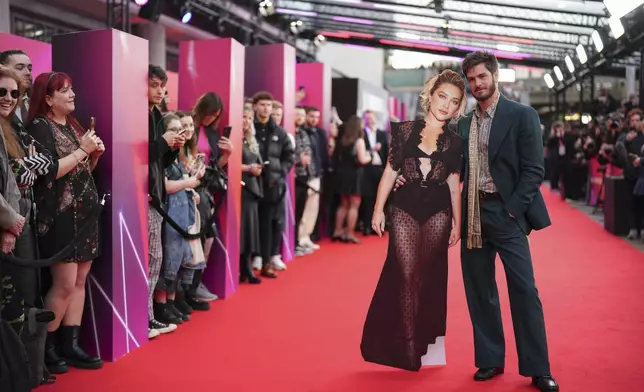 Andrew Garfield poses with a cut out of fellow actor Florence Pugh upon arrival at the premiere for the film 'We Live In Time' on Thursday, Oct. 17, 2024, in London. (Photo by Scott A Garfitt/Invision/AP)