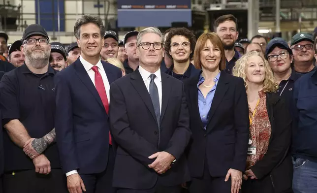 FILE - Britain's Prime Minister Keir Starmer, center, Chancellor of the Exchequer Rachel Reeves, right, and Secretary of State for Energy Security and Net Zero Ed Miliband visit a factory in Chester, England, Friday, Oct. 4, 2024.(AP Photo/Darren Staples, Pool, File)