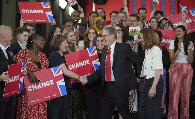 FILE - Labour Party leader Keir Starmer shakes hands with his supporters at the Tate Modern in London, Friday, July 5, 2024. (AP Photo/Kin Cheung, File)