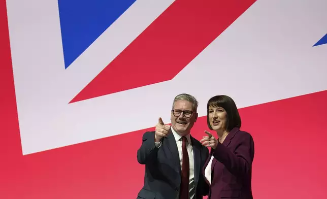 FILE - Britain's Prime Minister Keir Starmer and Britain's Chancellor of the Exchequer Rachel Reeves gesture after her speech at the Labour Party Conference in Liverpool, England, Monday, Sept. 23, 2024.(AP Photo/Jon Super, File)