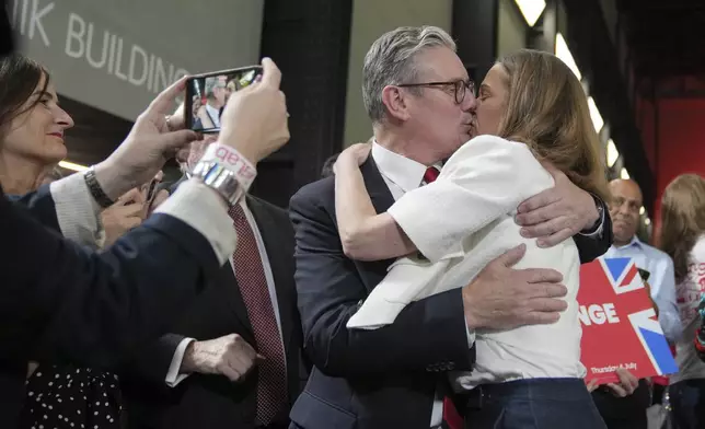 FILE - Labour Party leader Keir Starmer kisses his wife Victoria after he spoke to his supporters at the Tate Modern in London, Friday, July 5, 2024. (AP Photo/Kin Cheung, File)