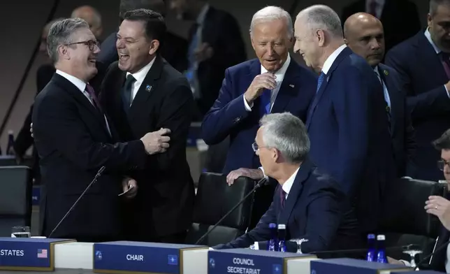 FILE - President Joe Biden arrives to attend Working Session II of the NATO Summit in Washington, Thursday, July 11, 2024. From left are British Prime Minister Keir Starmer, Portugal Prime Minister Luis Montenegro, Biden, and NATO Deputy Secretary General Mircea Geoana. Seated is Secretary General of NATO Jens Stoltenberg. (AP Photo/Jacquelyn Martin, File)