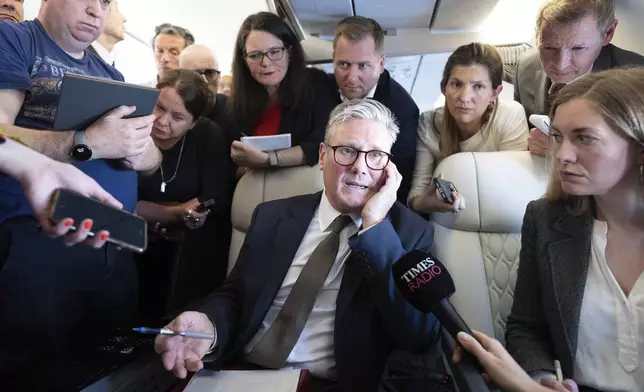 FILE - Britain's Prime Minister Keir Starmer talks to journalists as he travels onboard a plane to Washington DC to attend a Nato summit, Tuesday July 9, 2024. (Stefan Rousseau/Pool Photo via AP, File)