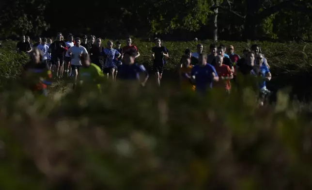 Runners compete in the parkrun event in Bushy Park, southwest London, Saturday, Sept. 28, 2024. (AP Photo/Alastair Grant)