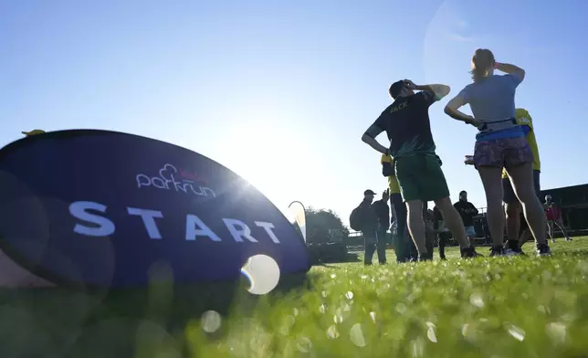 Competitors wait near the start of the parkrun event in Bushy Park, southwest London, Saturday, Sept. 28, 2024. (AP Photo/Alastair Grant)