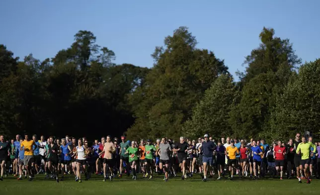 Runners compete in the parkrun event in Bushy Park, southwest London, Saturday, Sept. 28, 2024. (AP Photo/Alastair Grant)