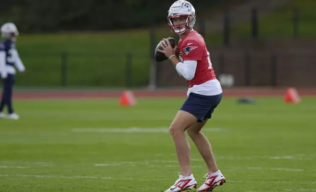 New England Patriots quarterback Drake Maye (10) works out during NFL football practice, Friday, Oct. 18, 2024, in Harrow, England. (AP Photo/Steve Luciano)