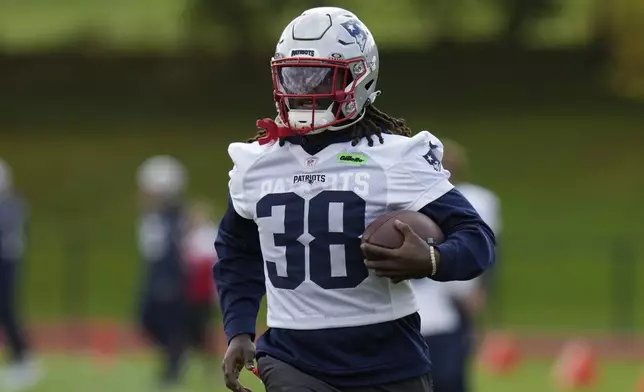 New England Patriots running back Rhamondre Stevenson (38) takes part in drills during NFL football practice, Friday, Oct. 18, 2024, in Harrow, England. (AP Photo/Steve Luciano)