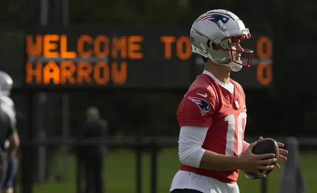 New England Patriots quarterback Drake Maye (10) works out during NFL football practice, Friday, Oct. 18, 2024, in Harrow, England. (AP Photo/Steve Luciano)