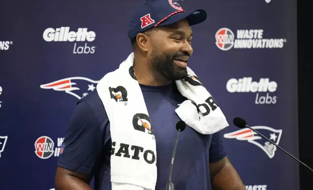 New England Patriots head coach Jerod Mayo speaks with media ahead of NFL football practice, Friday, Oct. 18, 2024, in Harrow, England. (AP Photo/Steve Luciano)