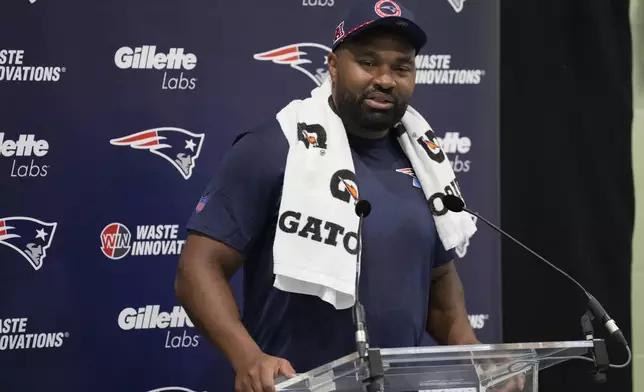 New England Patriots head coach Jerod Mayo speaks with media ahead of NFL football practice, Friday, Oct. 18, 2024, in Harrow, England. (AP Photo/Steve Luciano)