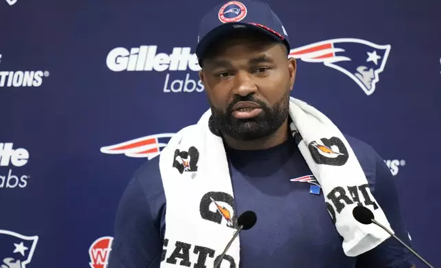 New England Patriots head coach Jerod Mayo speaks with media ahead of NFL football practice, Friday, Oct. 18, 2024, in Harrow, England. (AP Photo/Steve Luciano)