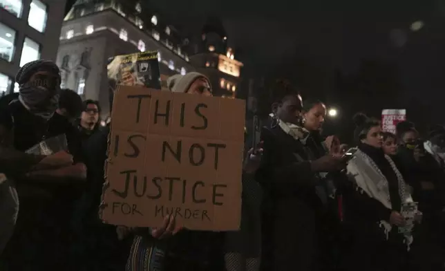 People demonstrate outside the Old Bailey in central London, Monday Oct. 21, 2024, after the London police officer who fatally shot Chris Kaba was acquitted of murder. (Jordan Pettitt/PA via AP)