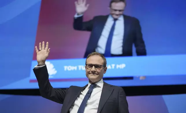 Conservative leadership candidate Tom Tugendhat waves to members during the Conservative Party Conference at the International Convention Centre in Birmingham, England, Wednesday, Oct. 2, 2024.(AP Photo/Kin Cheung)