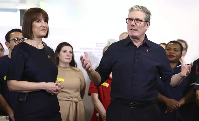 Britain's Prime Minister Keir Starmer and Chancellor Rachel Reeves speak with members of staff, during a visit to University Hospital Coventry and Warwickshire, in Coventry, England, Thursday, Oct. 31, 2024. (AP Photo/Darren Staples, pool)