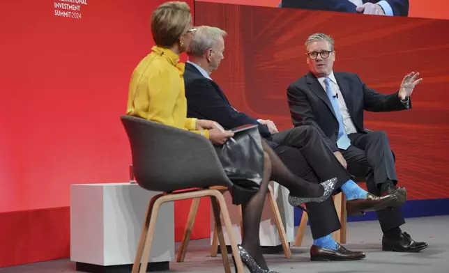 British Prime Minister Keir Starmer, right, sits in conservation with former CEO of Google, Eric Schmidt, center, and Emma Walmsley the CEO of GSK, during the International Investment Summit in London, Monday, Oct. 14, 2024. (Jonathan Brady/Pool Photo via AP)