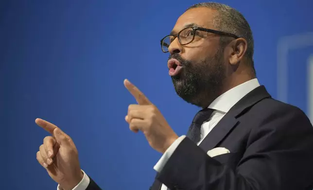 Conservative leadership candidate James Cleverly addresses members during the Conservative Party Conference at the International Convention Centre in Birmingham, England, Wednesday, Oct. 2, 2024.(AP Photo/Kin Cheung)