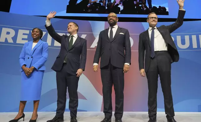 Conservative leadership candidates Kemi Badenoch, from left, Robert Jenrick, James Cleverly and om Tugendhat stand on the podium during the Conservative Party Conference at the International Convention Centre in Birmingham, England, Wednesday, Oct. 2, 2024.(AP Photo/Kin Cheung)