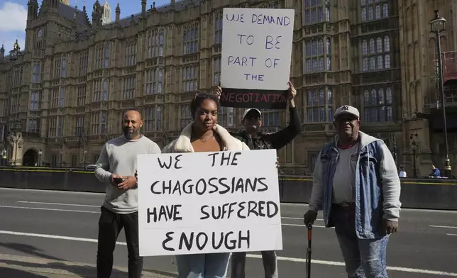 Chagossians Whitney Tranquille, center, attends a protest to response the U.K. announcement to agree to hand sovereignty of the long-contested Chagos Islands to Mauritius and against their "Exclusion" from Chagos negotiations, outside the House of Parliament, in London, Monday, Oct. 7, 2024. (AP Photo/Kin Cheung)